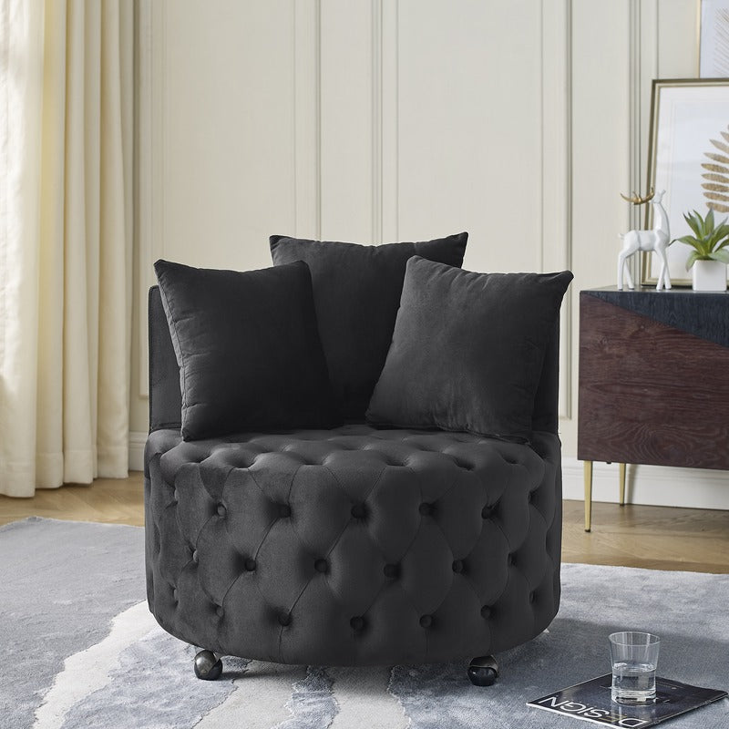 Black velvet swivel chair styled in a living room with pillows