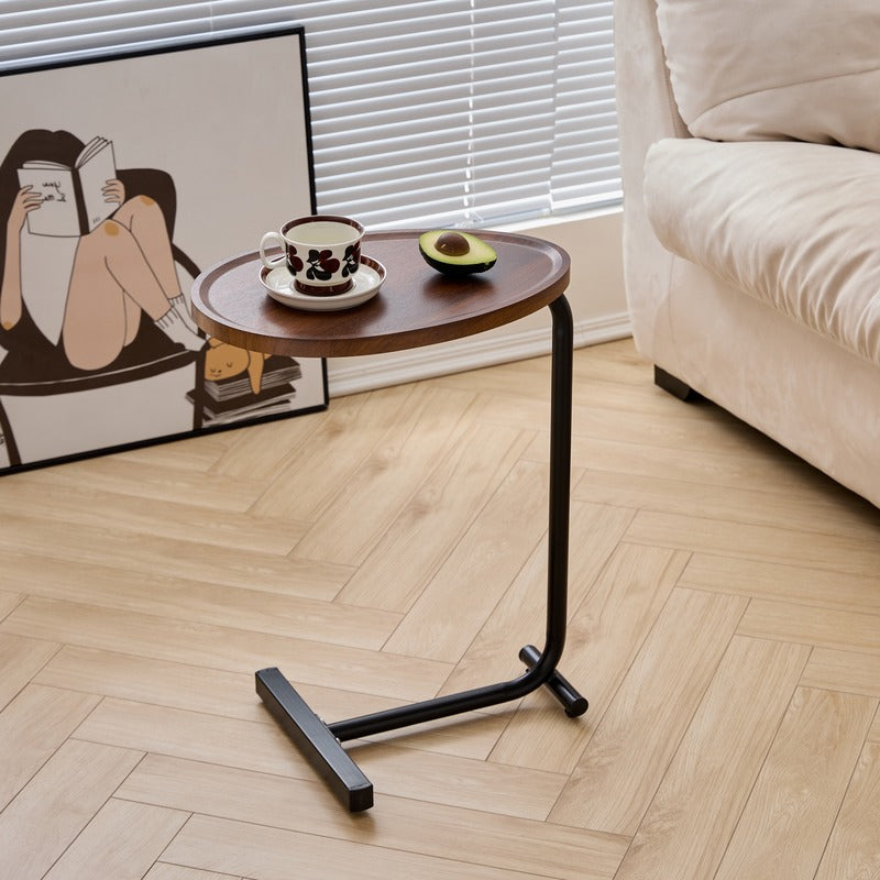 Brown C-shaped side table beside a sofa in a living room
