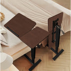 Rolling walnut overbed laptop table positioned beside a bed
