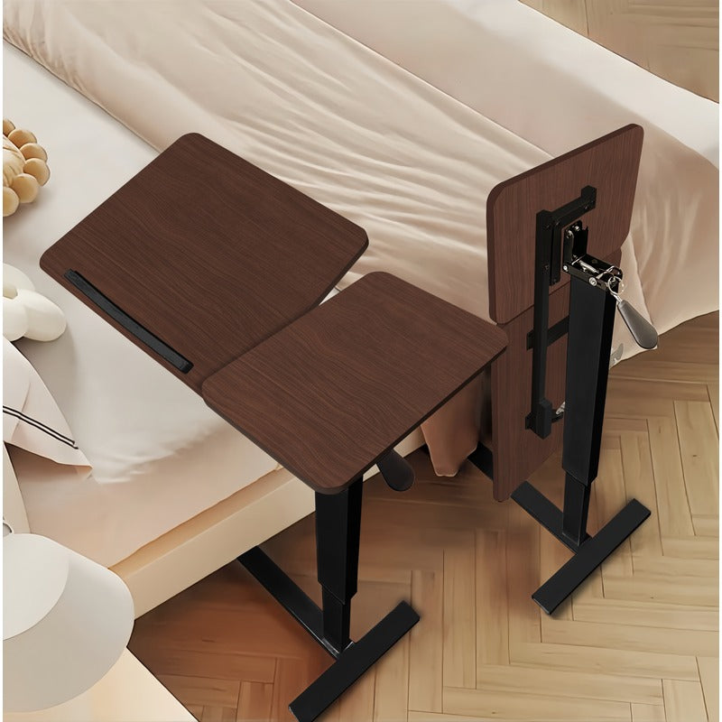 Rolling walnut overbed laptop table positioned beside a bed